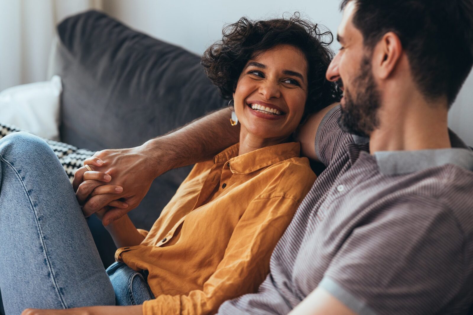 A smiling Latin-American woman and her Caucasian boyfriend enjoying spending their leisure time together.